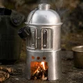 Canteen stove burning small sticks with silver canteen fitted above the wood fire
