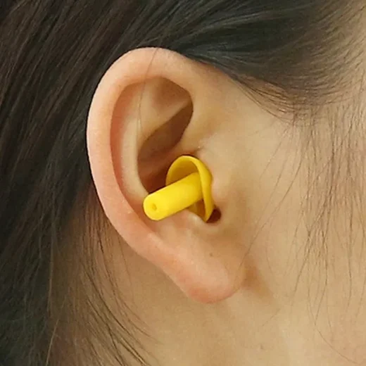 Yellow silicon earplug inside right ear