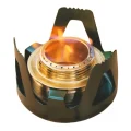 Close-up of alcohol stove burner with flame visible through the metal support