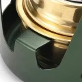 Close-up of the alcohol stove support slot holding the gold-coloured burner in place