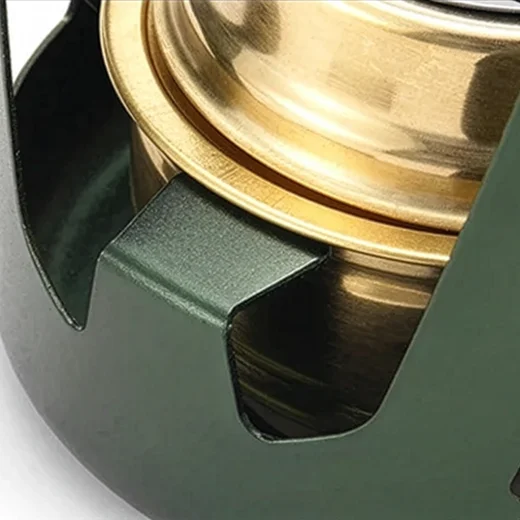 Close-up of the alcohol stove support slot holding the gold-coloured burner in place