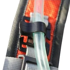 hydration hose clipped onto backpack strap with a black hose clip