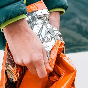 Close-up of the reflective foil lining inside the orange survival bag