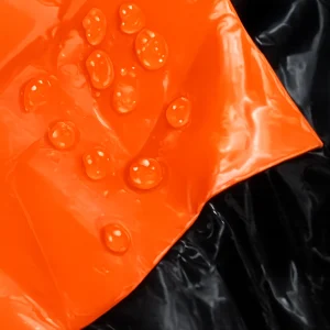 Close-up of water droplets on the orange survival bag material