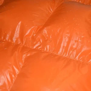 square baffle close up of orange down sleeping bag with water resistant fabric