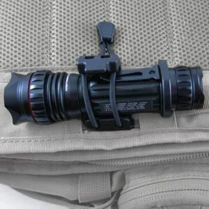 Utility clip holding torch to pack