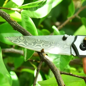 damascus look blade cutting branch