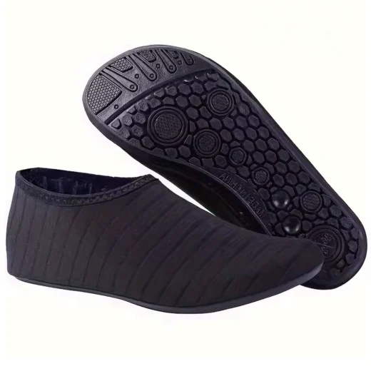 Pair of black swim shoes with one showing the flexible upper and the other displaying the grippy outsole