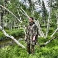 man wearing camo poncho without the hood