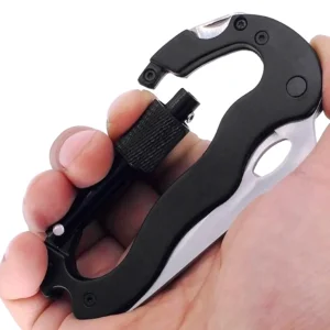 fold out carabiner knife held in a hand to show size