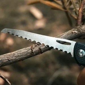 folding saw of pocket knife cutting a small branch