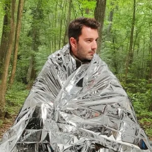 man wearing emergency survival blanket