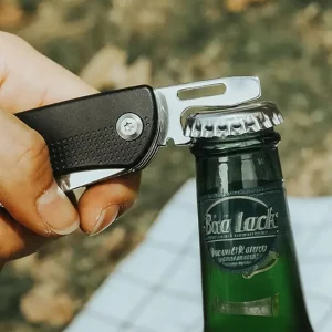 pocket knife used to open a bottle