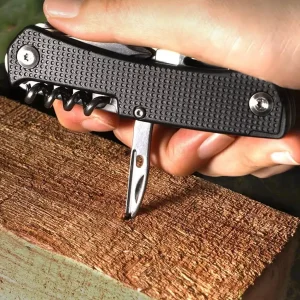 pocket knife used to drill a hole in wood