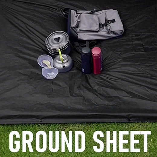 Black poncho tarp laid flat as a groundsheet with camping cookware and bag