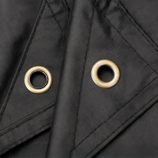 black hikera rain poncho close up of eyelet holes for using as a shelter