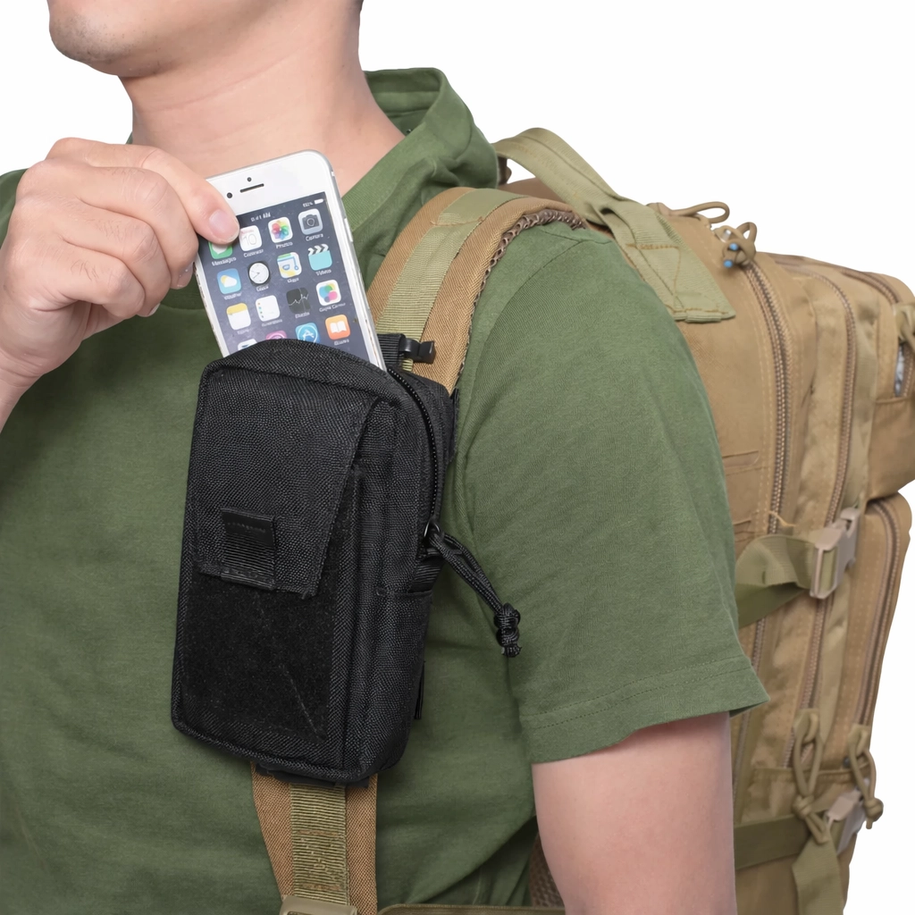 Black strap mounted pouch attached to backpack shoulder strap holding a phone