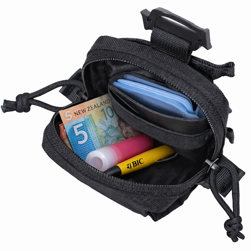 Open black pouch showing storage for cash cards pen and small daily carry items