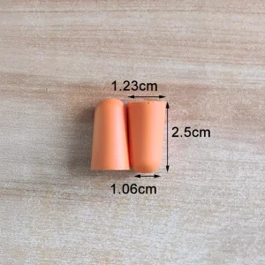 Orange foam ear plugs with size measurements shown on a wood background