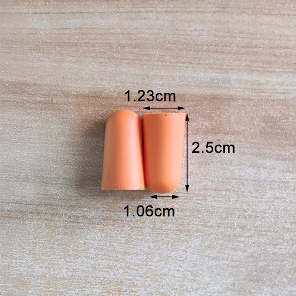 Orange foam ear plugs with size measurements shown on a wood background