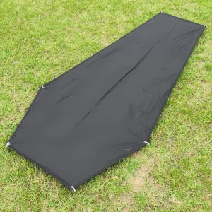 Black 210D Oxford cloth bivvy footprint on grass with metal corner eyelets for pegging