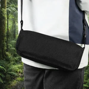 Black foldable stool carried with a shoulder strap for portable outdoor use