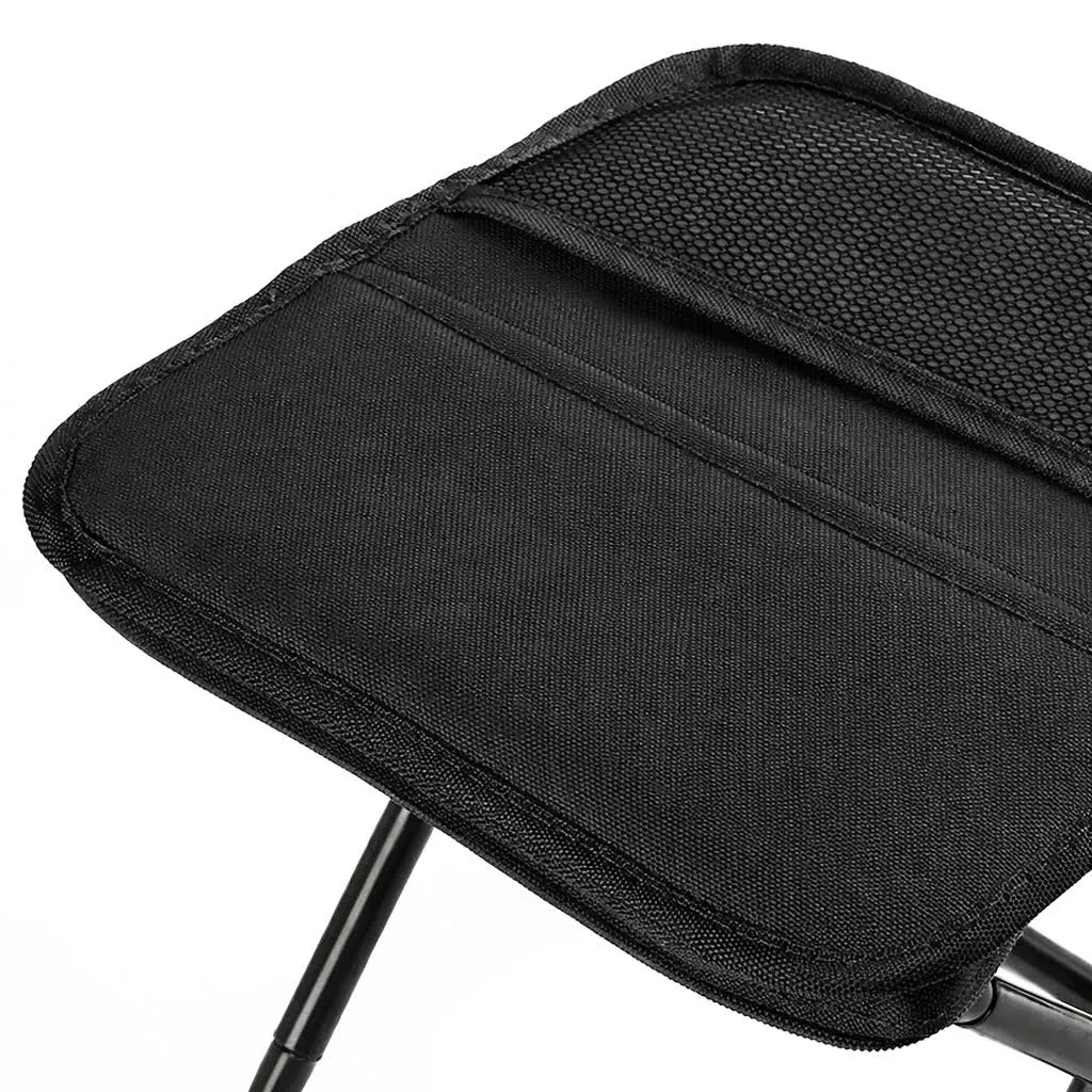 Close-up of the black fabric seat and stitched edge on a foldable stool