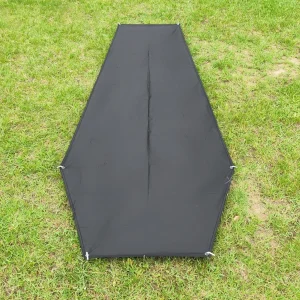 Tapered black bivvy footprint laid on grass showing the narrow end and wider shoulder section