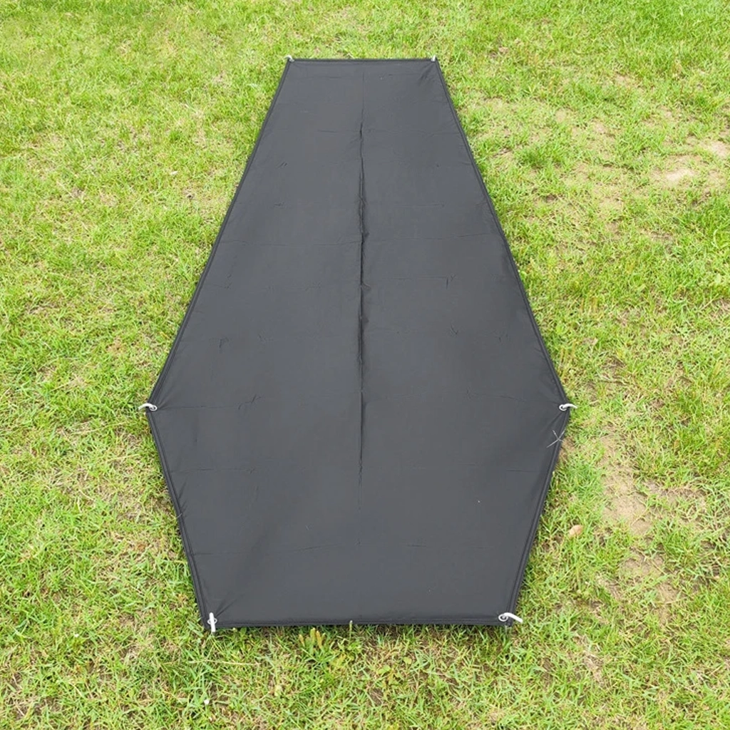 Tapered black bivvy footprint laid on grass showing the narrow end and wider shoulder section