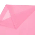 Close up of pink rain poncho side panel showing translucent EVA material and stitched edge