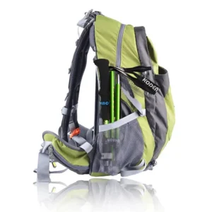 Folded green trekking pole carried in the side pocket of a hiking backpack