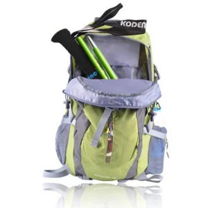 Folded green trekking pole stored inside the front pocket of a hiking backpack