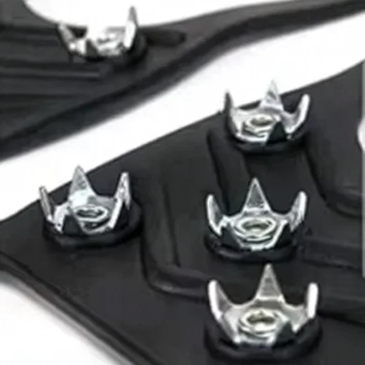 Close-up of the silver traction studs mounted in a black TPR ice grip