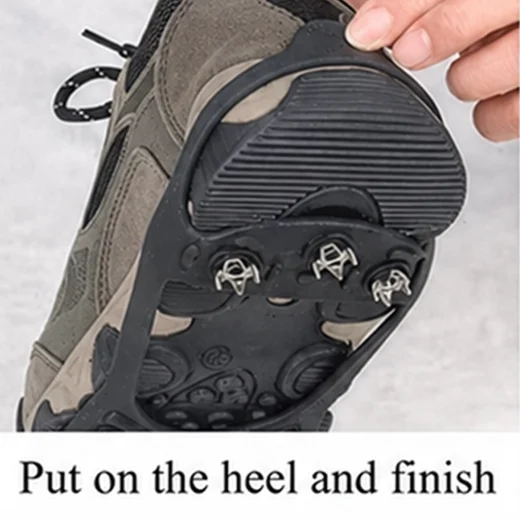 Hand pulling the rear section of a black ice grip over the heel of a hiking shoe