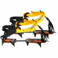 Pair of Vuno Capricorn 10 tooth crampons with orange sole sections, black frames and yellow buckle straps.