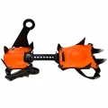 Underside view of one 10 tooth crampon showing orange plates, black steel points and the adjustable centre bar