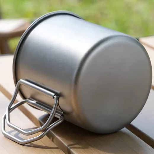 mping cup resting on its side showing the base and folding handle